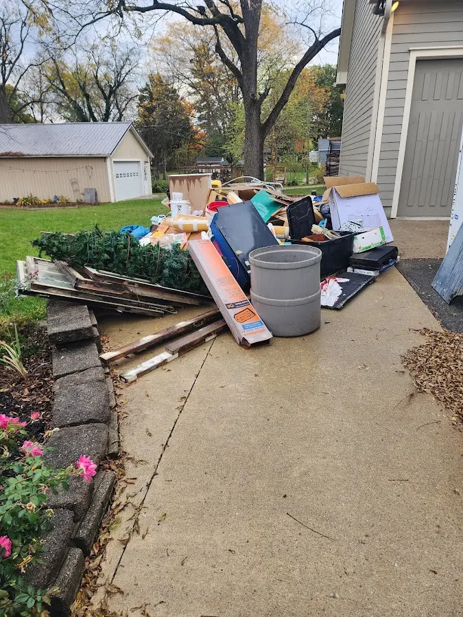 Dumpster being loaded with debris for Residential Dumpster Rental in Woodstock
